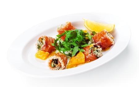 Restaurant food - smoked salmon rolls with arugula isolated at the white backgroundの写真素材