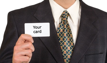 Man's hand is showing blank business card. He is in black suit, white shirt and tie.の写真素材