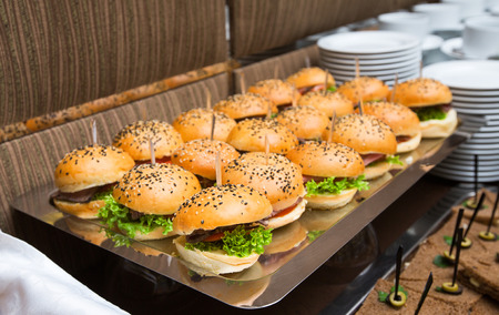 Catering american style - served table with plenty of hamburgers and other snacksの写真素材