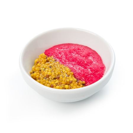 Set of two sauces in a bowl, beetroot horseradish and french mustardの写真素材