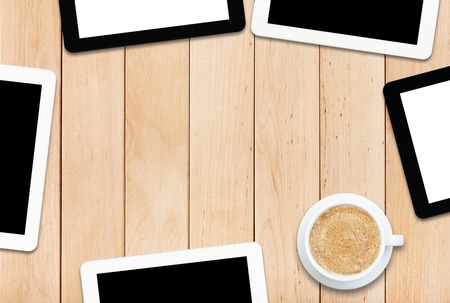 Group of tablets PC and coffee on a wooden tableの写真素材