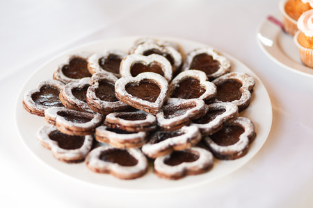Served festive candy bar table with heart shaped buiscuits closeupの写真素材