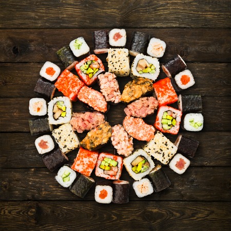 Japanese food restaurant delivery - sushi maki california roll platter set isolated at wooden background, above viewの写真素材