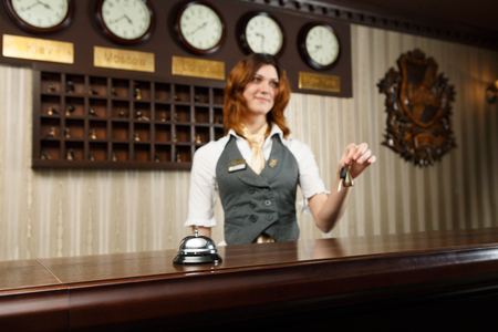 Hotel receptionist gives keys to a guest.の写真素材