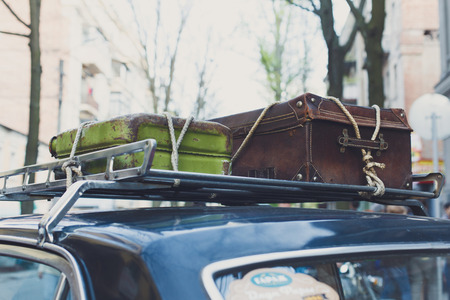 Vintage suitcases on a car roof.の写真素材