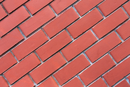 Red brick wall background. Modern wall with smooth decorative false bricks texture. Brickwall stucco...