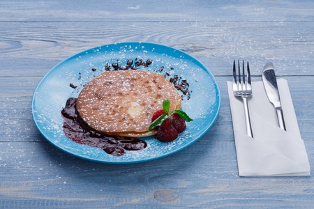 Restaurant dessert meal. Classic american pancakes served with raspberry sauce and fresh berries....