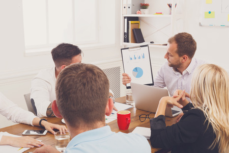 Business corporate meeting of young team. Modern businessman show diagram of company success on...