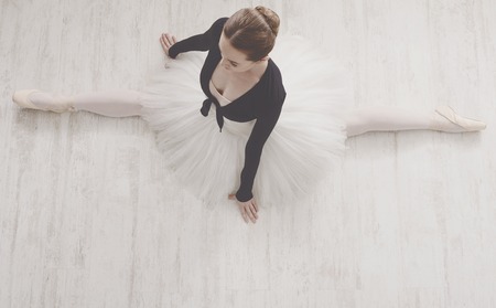 Classical Ballet dancer portrait. Beautiful graceful ballerine in tutu skirt practice split ballet...