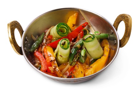 Vegan and vegetarian dish, spicy vegetable salad in bowl. Indian cuisine, cucumber, sesame and pepper mix with herbs, healthy meal isolated on white background. Eastern local cuisine restaurant food.の写真素材
