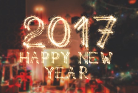 2017 New year font made from sparkler firework on decorated room background. Two thousand seventeen numbers from sparkling burning flames. Illuminated date figures, pattern for calendarの写真素材