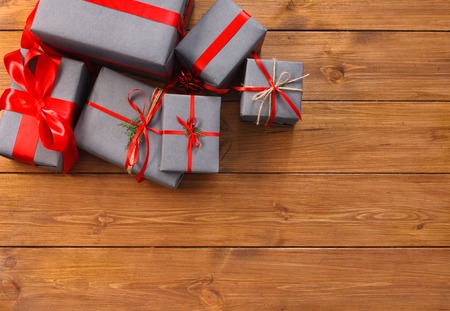 Presents for any holiday concept. Gift boxes frame, top view with copy space on wood table...