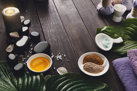 Spa treatment and aromatherapy concept background. Zen stones, aroma salt, spices, burning candle, oil and soap, candle and other details of wellness body care and alternative indian medicine.の写真素材