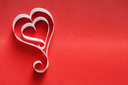 Valentine background with handmade paper heart shapes decoration on red. Happy lovers day card mockup, copy spaceの写真素材