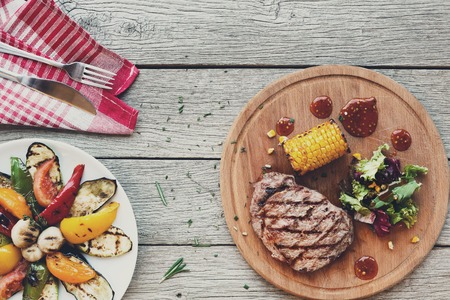 Grilled beef steak closeup on dark wooden table backgroundの写真素材