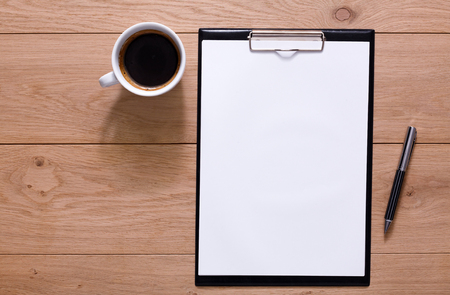 Mockup for check list, empty note paper with pen and coffee cup on brown wood background. Office, writer or study conceptの写真素材
