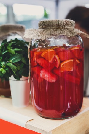 Closeup of lemonades in glass jars at restaurant background. Refreshing drinks in craft containers with sack on bar counterの写真素材