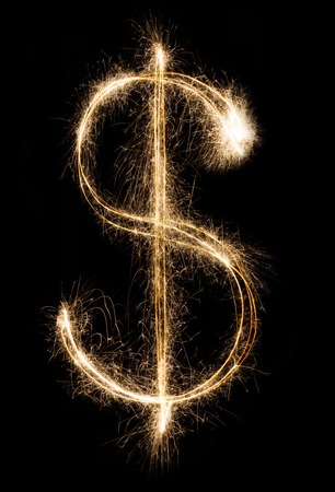 Money and finance business concept. Dollar sign from shining sparkler firework on black backgroundの写真素材