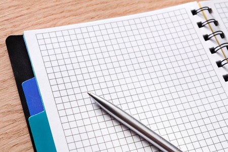 Notepad and personal diary or organizer closeup, writing to do list concept. Office or students...