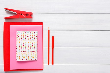 Valentines day scrapbooking, wedding or other holiday decorations background. Handmade diy tools for creating cards, cut and paste colored paper on white wood. Above view, flat layの写真素材
