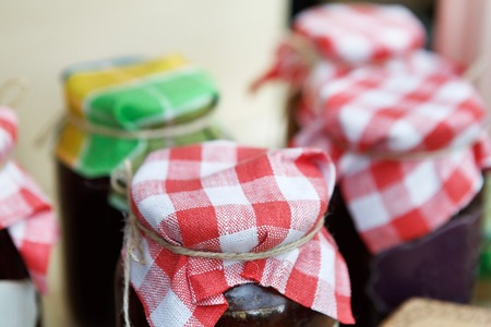 Homemade jams in glass jars for sale on country fair. Fresh healthy organic sweet preservesの写真素材