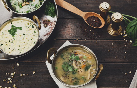 Vegan and vegetarian dish, hot spicy and creamy mushroom indian soup bowl. Traditional indian cuisine meal on wooden served table background. Healthy eastern local cuisine restaurant foodの写真素材