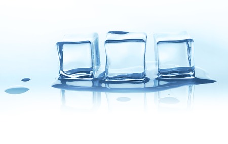 Group of three melting ice cubes with reflection isolated on white background. Closeup of cold crystal block cutoutの写真素材