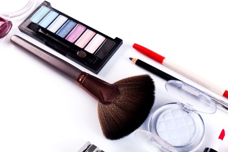 Makeup cosmetics, brushes and other essentials on white background. Flat lay. Multicolored beauty tools and products collection, lipsticks, eyeshadow, pencils, blushの写真素材
