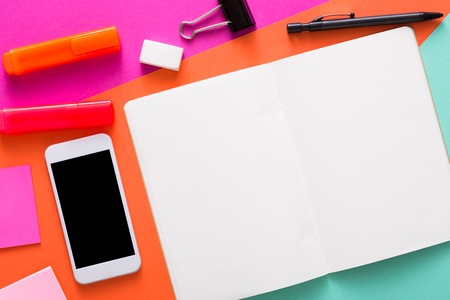 Creative minimal design - flat lay of workspace desk with stationery, mobile smart phone, blank sketchbook or tablet with copy space. Template, mockup, objectsの写真素材