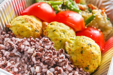Healthy food delivery closeup diet concept. Take away of fitness meal. Weight loss lunch in foil...