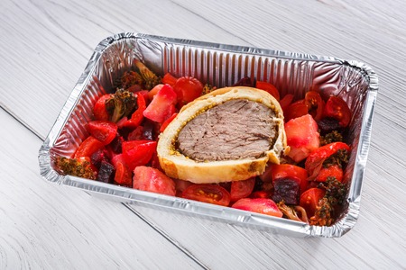 Healthy food background, take away of natural organic meals in foil container. Fitness nutrition, meat roll and beetroot salad closeup. Restaurant dishes deliveryの写真素材