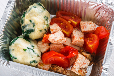 Healthy food background, take away of natural organic meals in foil container. Fitness nutrition, meatballs and vegetables closeup. Restaurant dishes deliveryの写真素材