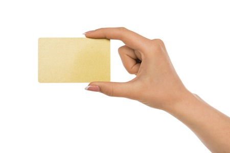 Close-up side view shot of hand holding plastic credit card , woman showing blank business card on white isolated studio background, copy space, cutoutの写真素材