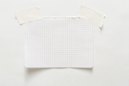 Lined note paper with sticky tape. Paper piece on white notice board, office and business stationary, blank copy space for text, templateの写真素材