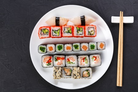 Japanese food restaurant, california salmon rolls and sushi platter. Set with chopsticks and soy...