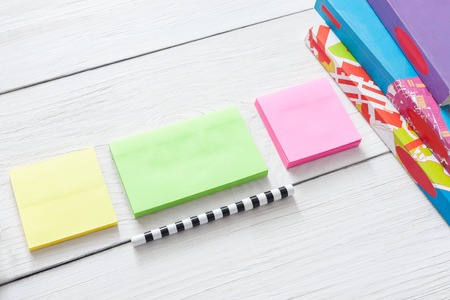Flat lay of office and business stationery supplies - colorful sticky notes and memo blocks,...