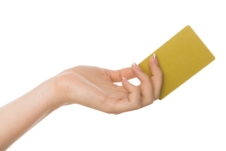 Hand holding plastic credit card , woman showing blank business card on white isolated studio background, copy space, cutoutの写真素材