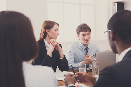 Business people friendly discussion, meeting of multiethnic team. Office strategy planning, communication with partnersの写真素材