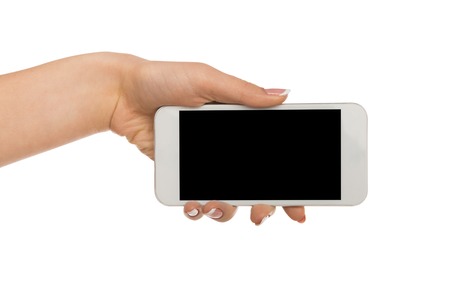 Woman hand hold mobile phone display, cutout. Female with modern smartphone, white isolated background, copy spaceの写真素材