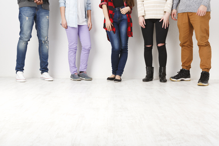 Communication. Crop of diverse informal people standing in row indoors on white studio backgroundの写真素材