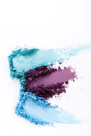 Makeup strokes, cosmetics background. Eyeshadow crushed palette, blue and violet colorful powder on white, art of make-upの写真素材