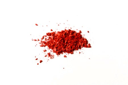 Makeup splash, cosmetics background. Blush crashed palette, red colorful powder on white, art of make-upの写真素材