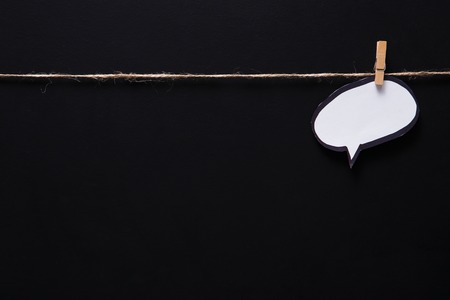 Blank speech bubble for presenting creative idea or business solution on black studio background,...