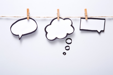 Creative ideas concept. Blank speech bubbles hadcrafted on white background, top view, copy space for textの写真素材