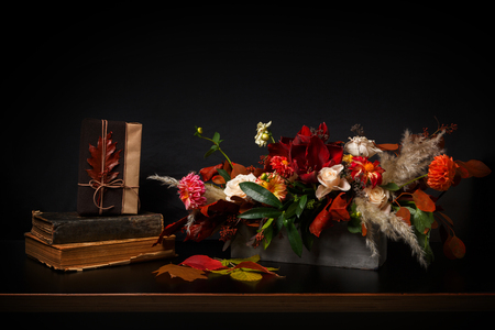 Beautiful flowers still life. Flower shop composition bouquet on black wood background. Florist art and floral design conceptの写真素材