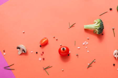 Diet, detox and healthy food concept - top view flat lay of fresh organic raw vegetables on abstract bright background. Ingredients for salad - broccoli, mushroom, carrot, cherry tomato, spinachの写真素材