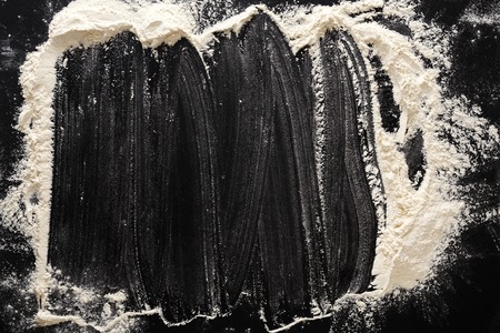 Flour on black, baking background with copy spaceの写真素材