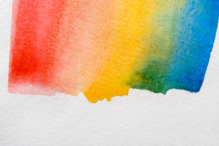 Bright watercolor rainbow. Creative abstract hand painted background on paper, texture, blue and violet colored paintingの写真素材