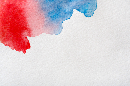 Abstract bright watercolor spots painted texture background. Red, violet and blue on white with copy spaceの写真素材