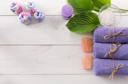 Spa treatment and aromatherapy top view background with copy space on white wood. Aroma salt, herbal balls for indian spaの写真素材